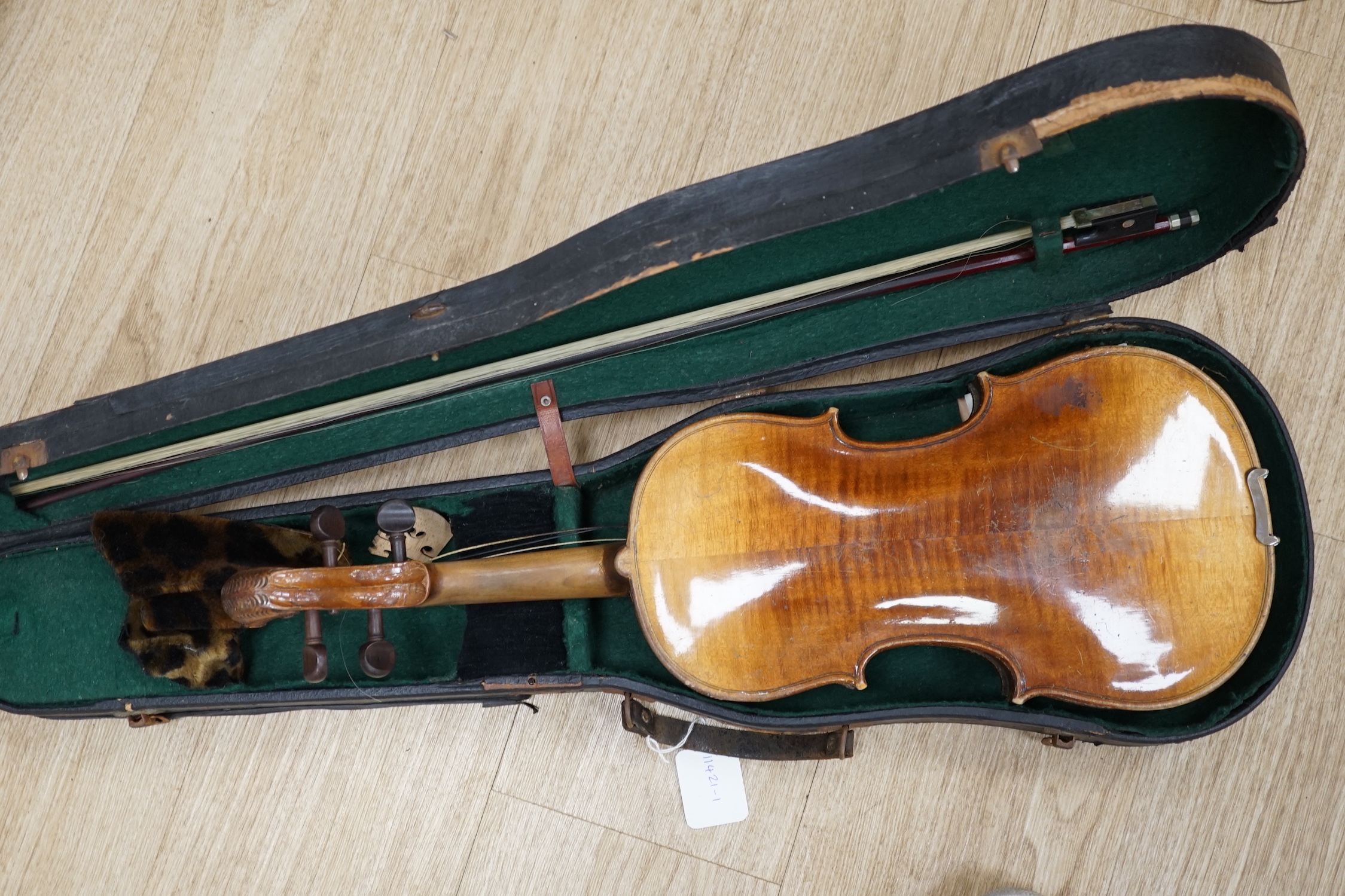 A cased 19th century Continental violin with lions head carved scroll, length of body, 35.5cm, with bow CITES Submission reference T5V8RCZY